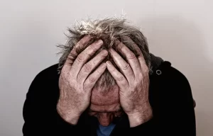 man holding his head as he is experiencing a headache